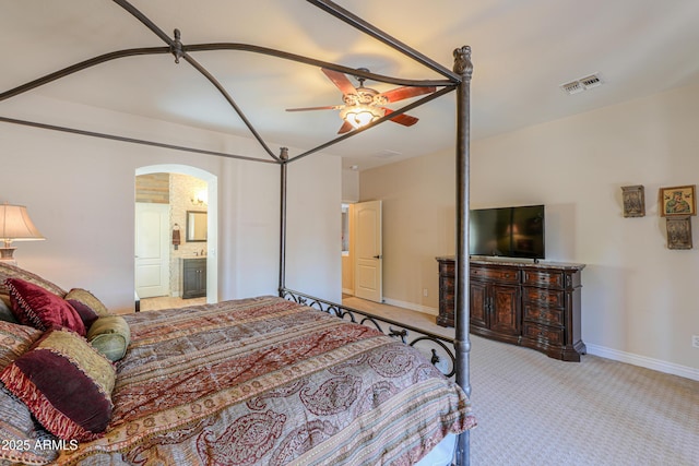 2041 E Palm Beach Dr, Chandler, AZ 85249 - carpeted bedroom with arched walkways, ceiling fan, and ensuite bathroom