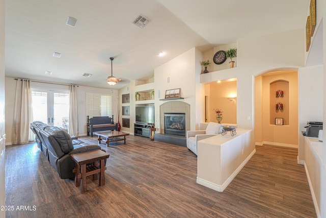 2041 E Palm Beach Dr, Chandler, AZ 85249 - living room featuring lofted ceiling, dark wood-style floors, arched walkways, and a fireplace