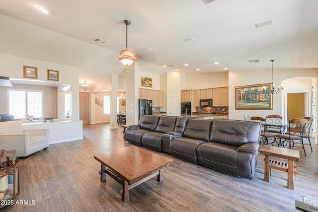 2041 E Palm Beach Dr, Chandler, AZ 85249 - living area with a chandelier, arched walkways, wood finished floors, recessed lighting, and high vaulted ceiling