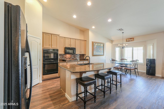 2041 E Palm Beach Dr, Chandler, AZ 85249 - kitchen featuring black appliances, lofted ceiling, a center island with sink, a chandelier, and dark wood-type flooring