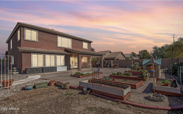 1805 E Aloe Pl, Chandler, AZ 85286 - back of house featuring a fenced backyard and a vegetable garden