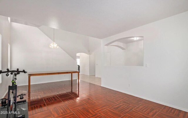 1805 E Aloe Pl, Chandler, AZ 85286 - additional living space with baseboards, vaulted ceiling, and arched walkways