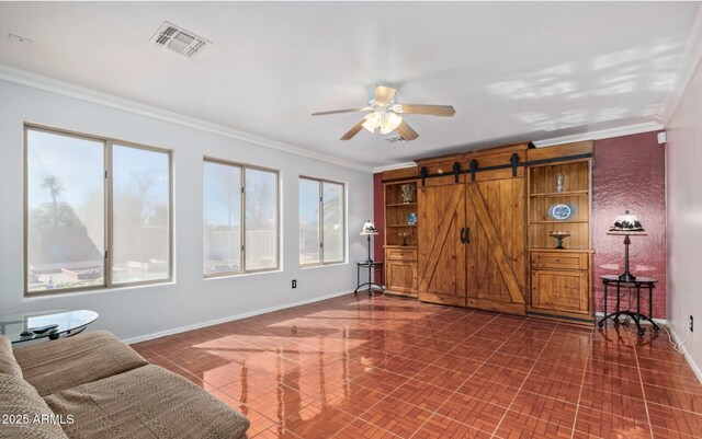 1805 E Aloe Pl, Chandler, AZ 85286 - living room featuring a barn door, baseboards, visible vents, ceiling fan, and ornamental molding