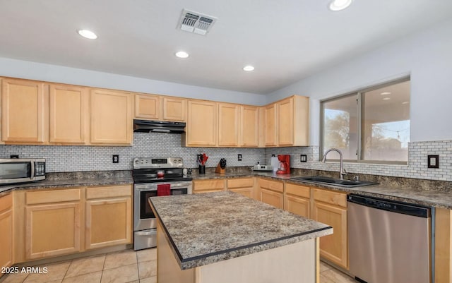 1805 E Aloe Pl, Chandler, AZ 85286 - kitchen with under cabinet range hood, a sink, visible vents, light brown cabinets, and appliances with stainless steel finishes
