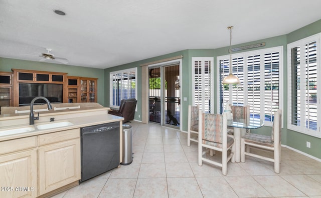 kitchen featuring dishwasher, a sink, a ceiling fan, and light tile patterned floors