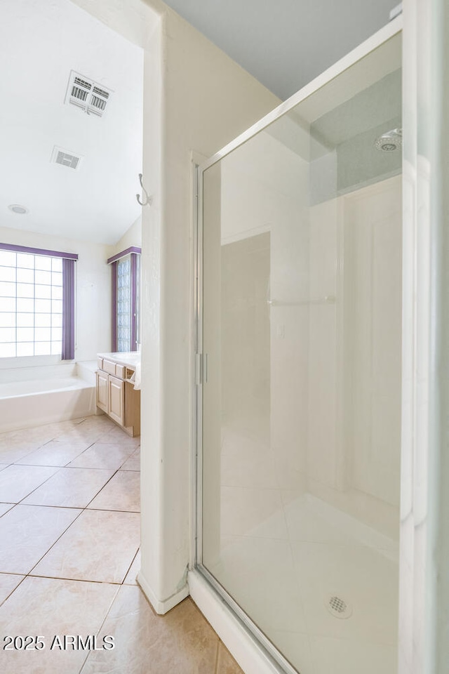 bathroom featuring a shower stall, tile patterned floors, visible vents, and a garden tub