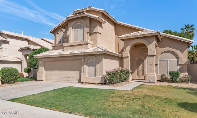 view of front of property with a front yard, a garage, a tile roof, stucco siding, and driveway