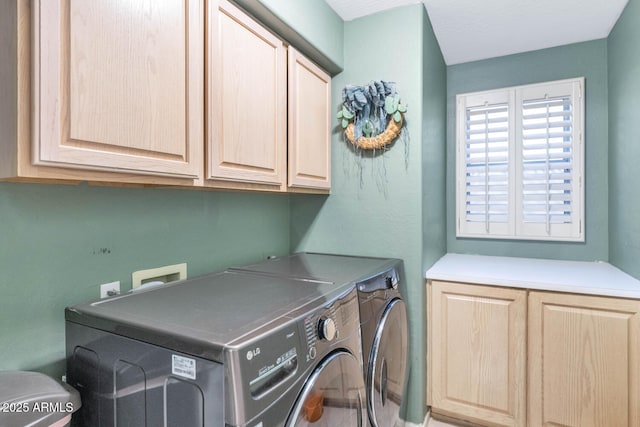 laundry room with washing machine and dryer and cabinet space