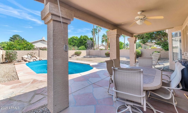 view of patio / terrace featuring a fenced in pool, a fenced backyard, outdoor dining space, and ceiling fan