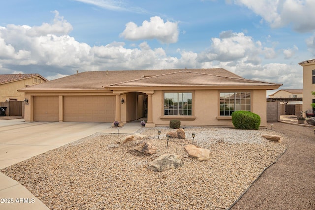 ranch-style house featuring concrete driveway, stucco siding, an attached garage, a tile roof, and fence