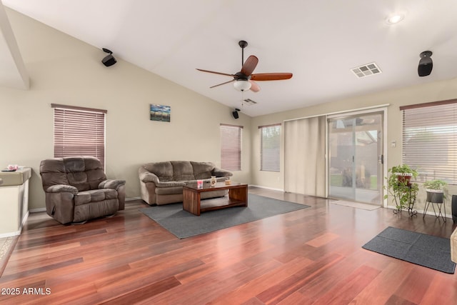 living room featuring wood finished floors, lofted ceiling, a ceiling fan, and visible vents