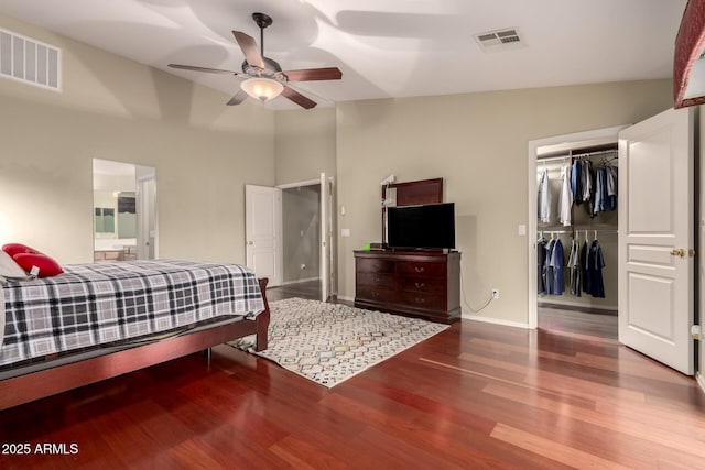 bedroom featuring wood finished floors, a closet, a spacious closet, and visible vents