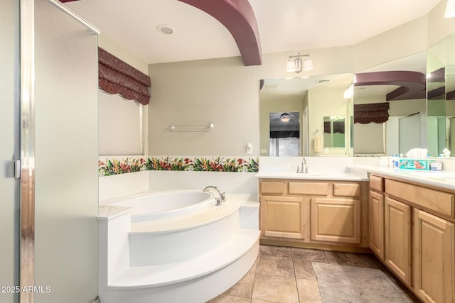 full bath with vanity, a bath, and a stall shower