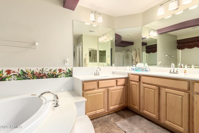 full bathroom featuring a sink, double vanity, a stall shower, and a garden tub