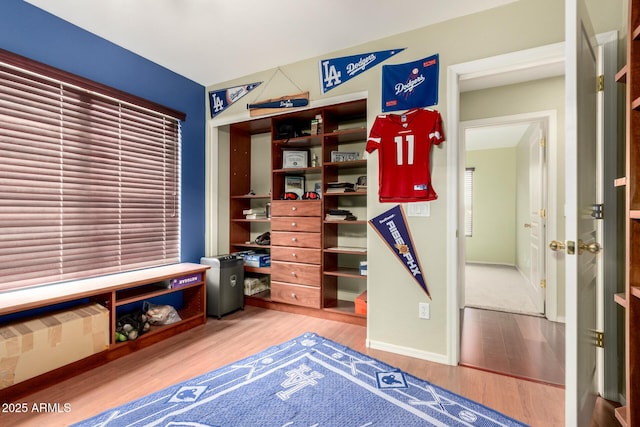 interior space with wood finished floors and baseboards