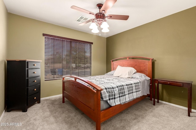 carpeted bedroom featuring visible vents, baseboards, and a ceiling fan