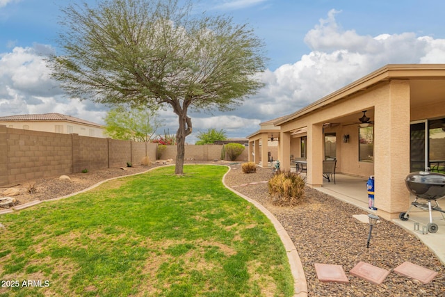 view of yard featuring a patio, a fenced backyard, and a ceiling fan