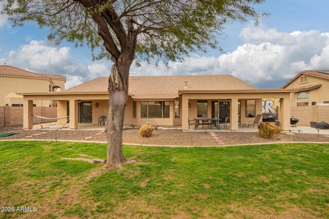 back of house with a yard, a patio, and fence