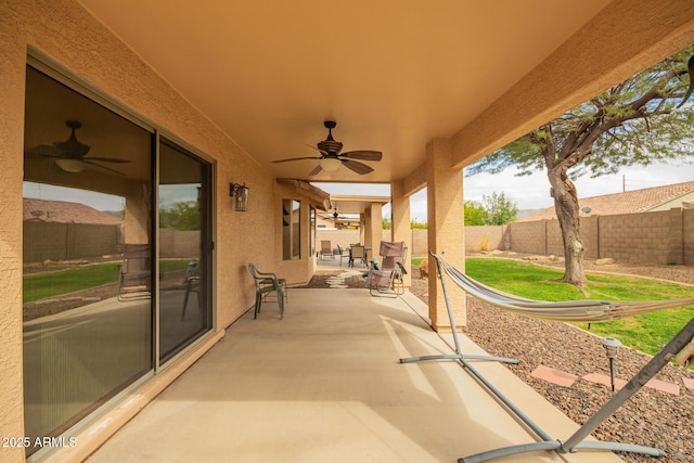 view of patio featuring a fenced backyard and a ceiling fan
