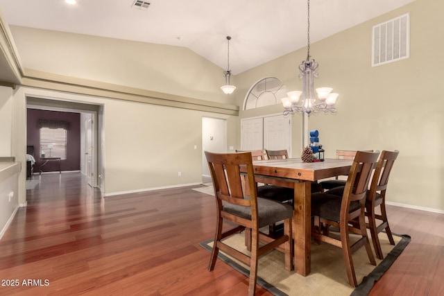 dining room featuring visible vents, baseboards, a chandelier, wood finished floors, and high vaulted ceiling