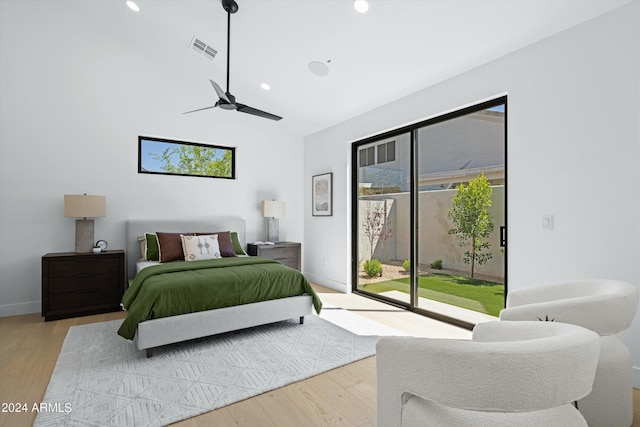 bedroom featuring access to outside, light hardwood / wood-style floors, and ceiling fan