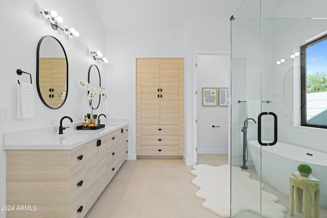 bathroom featuring vanity, a bath, and tile patterned floors