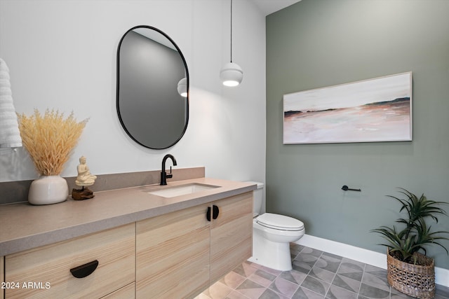 bathroom featuring tile patterned flooring, vanity, and toilet