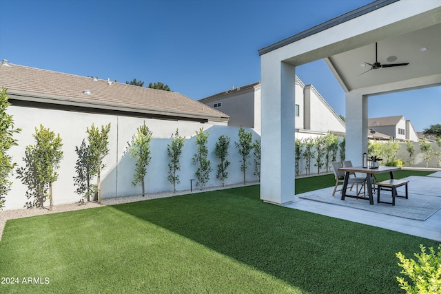 view of yard with ceiling fan and a patio