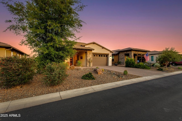 4577 Tenderfoot Way, Wickenburg, AZ 85390 - view of front of property with stucco siding, driveway, stone siding, and a garage
