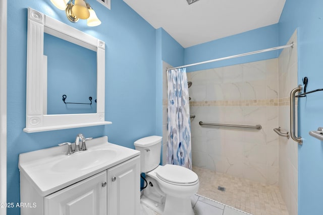 bathroom featuring tiled shower, vanity, and toilet