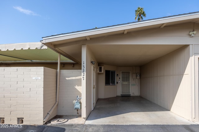 view of exterior entry featuring a carport