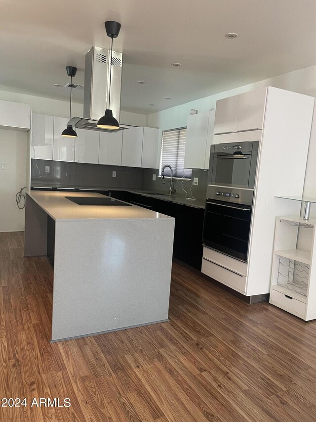 8520 E Mackenzie Dr, Scottsdale, AZ 85251 - kitchen featuring modern cabinets, white cabinetry, dark wood-type flooring, a kitchen island, and recessed lighting