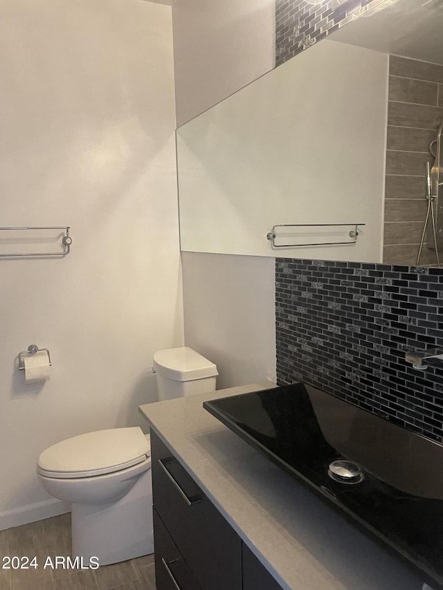 8520 E Mackenzie Dr, Scottsdale, AZ 85251 - bathroom featuring decorative backsplash, toilet, wood finished floors, and vanity
