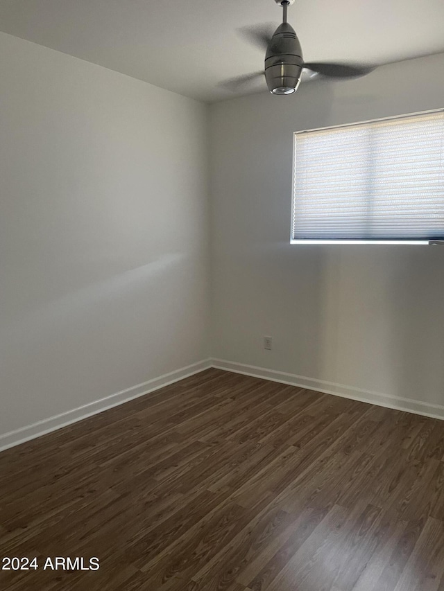 8520 E Mackenzie Dr, Scottsdale, AZ 85251 - unfurnished room with ceiling fan, dark wood-style floors, and baseboards