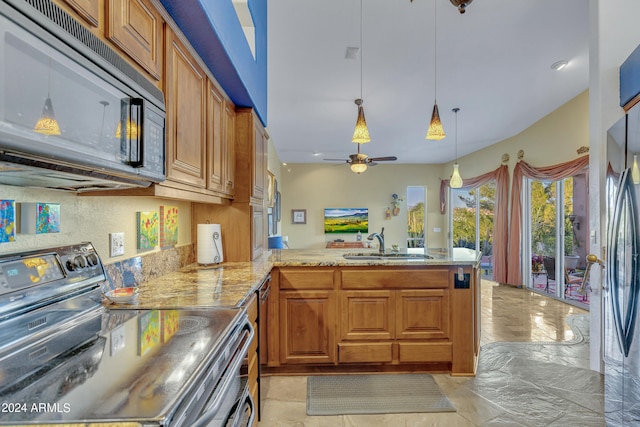 kitchen featuring ceiling fan, pendant lighting, sink, kitchen peninsula, and stainless steel appliances