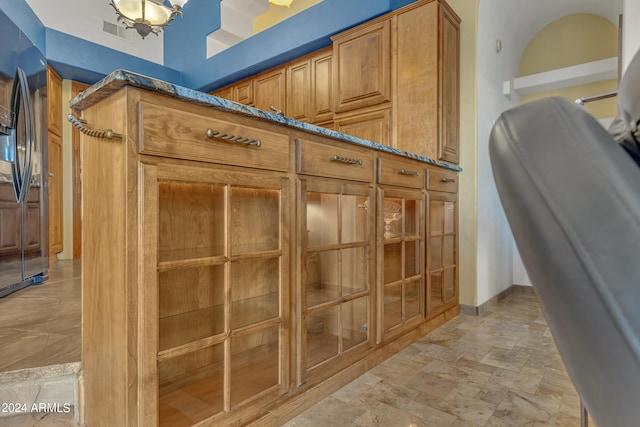 room details featuring black refrigerator with ice dispenser