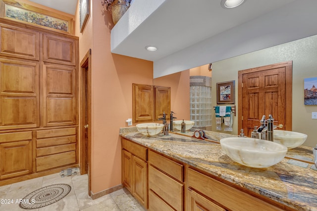 bathroom featuring tile patterned flooring and vanity