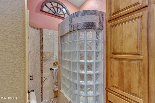 bathroom with a tile shower