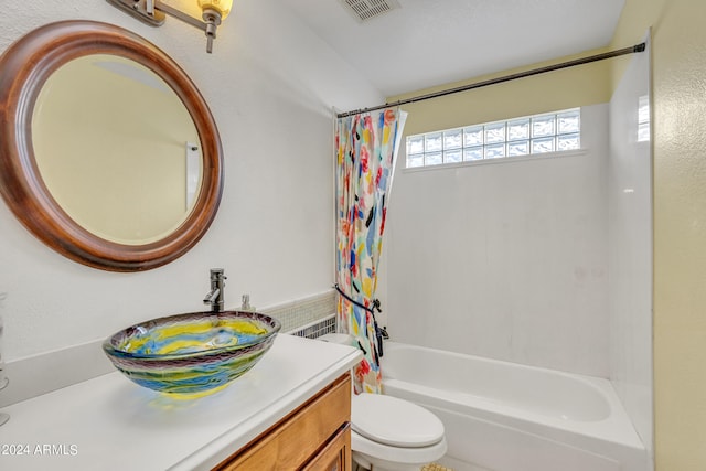 full bathroom featuring shower / bath combo, vanity, and toilet