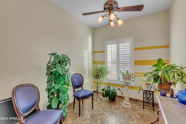 living area featuring ceiling fan