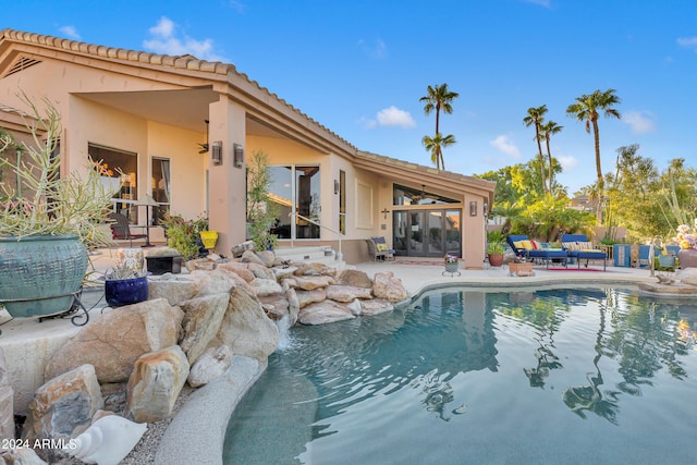 view of pool featuring ceiling fan, a sunroom, and a patio