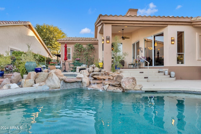 view of swimming pool featuring ceiling fan, a patio area, and pool water feature