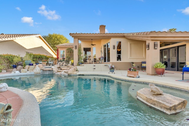 view of swimming pool featuring a patio and ceiling fan