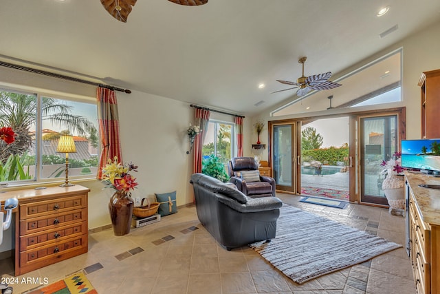 tiled living room with lofted ceiling and ceiling fan