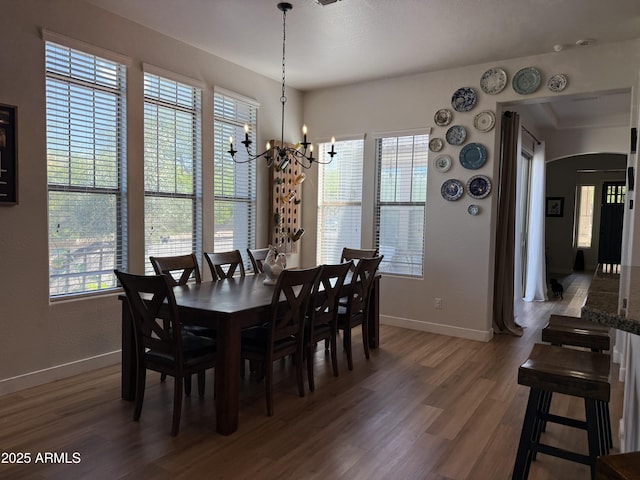 3765 N Denny Way, Buckeye, AZ 85396 - dining area with wood finished floors, a chandelier, and arched walkways