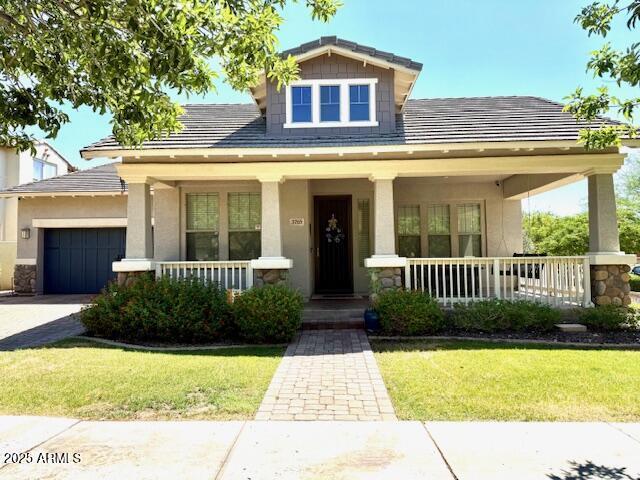 3765 N Denny Way, Buckeye, AZ 85396 - view of front of property with covered porch, a garage, a front yard, and concrete driveway