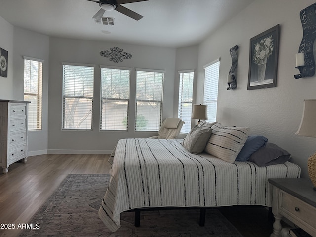 3765 N Denny Way, Buckeye, AZ 85396 - bedroom featuring multiple windows, wood finished floors, and a ceiling fan