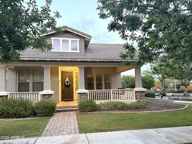 3765 N Denny Way, Buckeye, AZ 85396 - craftsman-style home featuring a porch, stucco siding, stone siding, and a front lawn