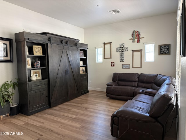 3765 N Denny Way, Buckeye, AZ 85396 - living room featuring light wood-style flooring and a barn door