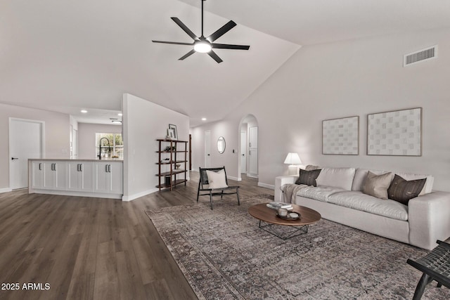 living room featuring ceiling fan, dark wood-type flooring, and high vaulted ceiling